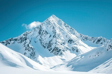 Fototapeta premium Snow-Covered Mountain Peak with Clear Blue Sky