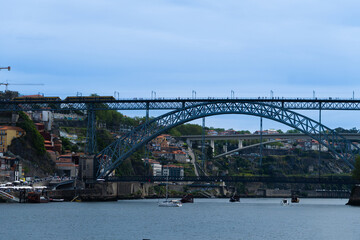 View of Porto city and Douro river and Dom Luis bridge. Porto, Vila Nova de Gaia, Portugal. Cityscape along the river