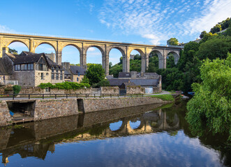 Fototapeta premium Historical viaduct above the Port de Dinan, reflecting in river Rance, Brittany, France