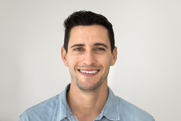 Happy handsome young Hispanic model guy looking at camera with toothy smile. Cheerful positive...