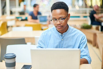 Fototapeta premium Working, black man and laptop in office for research, planning and typing for article information. Workplace, male journalist and digital with connection for business, publication and website ideas