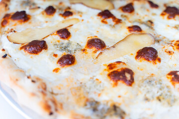Cheese pizza with pear close-up. Background