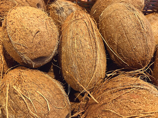 Close up of many Coconuts in a basket