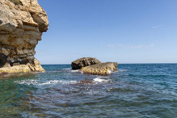 View from the water of picturesque coastline with cliffs and caves by Adriatic Sea, Polignano a...
