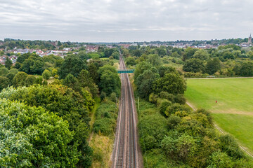 Aerial drone shot of rail tracks in the middle of a rural area in UK