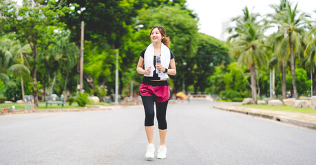 Asian woman exercise and fitness at outdoor thirsty drinking water from pet bottle