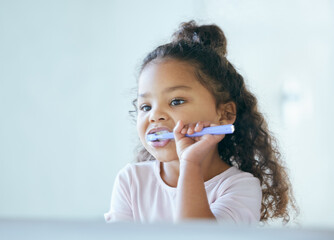 Girl, brushing teeth and mirror for hygiene, clean mouth and fresh breath for oral care and dental health. Child, cleaning and toothpaste with toothbrush, bathroom and wellness in family home