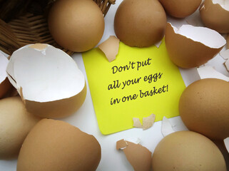 Empty broken eggshells with yellow sticky note and text 