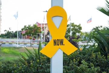 “Bring them home now” Installation of yellow ribbons in park, tied between trees as a symbol...