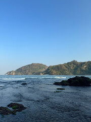 beachscape with wave and rock
