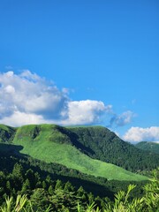 landscape with green hills and clouds. Summertime in the mountains.