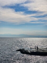 Chill out at the shore in the summertime. Standing and looking out at the blue sky.