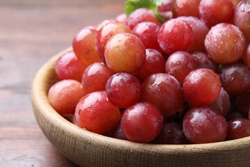 Fresh ripe grapes on wooden table, closeup