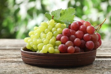Fresh ripe grapes on wooden table, closeup