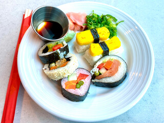Plate of delicious Japanese sushi wasabi seaweed garnish and soy dipping sauce