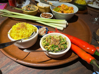 Rice, curry, salad, chillis and lemon grass adorn a restaurant table in Bali Indonesia