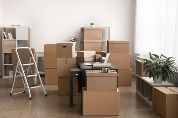 Stockroom filled with multiple various sizes cardboard boxes parcels stacked and arranged around...