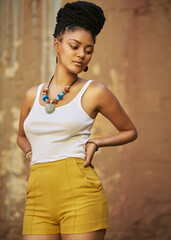 Fashion, street and African woman in city with casual outfit, trendy clothes and cool accessories. Attitude, ethnic aesthetic and person in style with confidence, pride and beauty on brown background