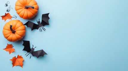 Halloween Concept , Orange Pumpkins, Black Bats, and Orange Leaves on Light Blue Background