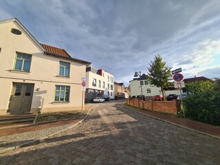 Obraz premium Spaziergang durch eine schöne Seitenstrasse mit strahlend blauem Himmel in Bad Doberan, Mecklenburg - Vorpommern