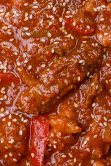 Thai Asian dish with meat, hot pepper, tomato sauce and sesame