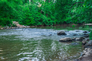 Naklejka na ściany i meble The gentle ripples carry the stories of Woodstock’s natural beauty, Little River, Woodstock, Georgia, United States of America