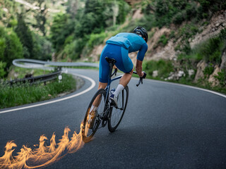 Fototapeta premium Cyclist on a racing bike pedaling and leaving a trail of fire on the road