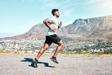 Running, outdoor and man with energy, nature and fitness of athlete, exercise and routine for race. Challenge, practice and preparing for speed of marathon, training or performance of runner in space