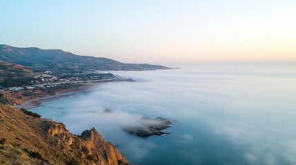 Obraz premium Dense fog covering a coastal town at dawn foggy weather