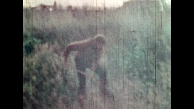 Treasure hunter digging shovel for treasure in wild field. Jewels search hidden underground. Male cowboy looking for pirate treasures. Lost buried hunt. Vintage color film. Retro discovery archive