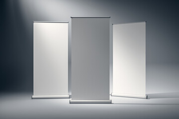 Three blank roll-up banners standing in a studio. 3D Rendering