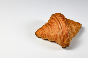 Freshly baked croissant,  Brown crispy croissants isolated on white background. French pastry closeup photo. Buttered bread croissant isolated on white background.