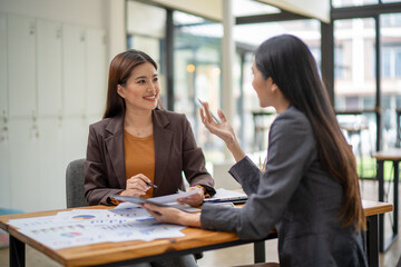 Two women are sitting at a table talking