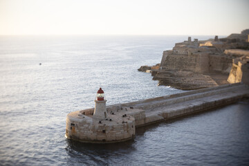 Lighthouse on an early morning entering the port in Valletta, Malta.