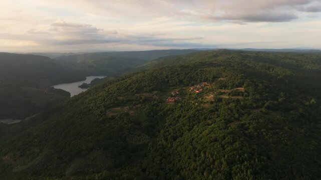 Mountain Village Of Marce With  River In Background