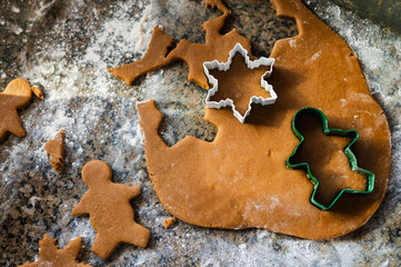 Gingerbread dough with festive cookie cutters, ready for baking