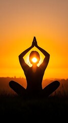 A silhouette of a person practicing yoga at sunrise, representing the harmony of body and mind in energy management