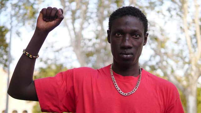 black lives matter -black man with clenched fist looks at the camera