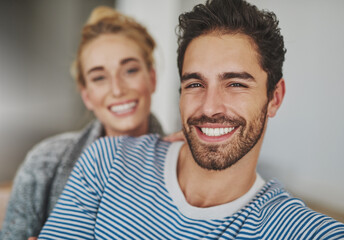 Obraz premium Couch, portrait and couple together on sofa for bonding, care and affection for romance in home. Woman, man and happy in lounge, apartment or house for weekend relaxing rest in living room with smile