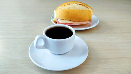  Cup of coffee and french bread on the plate and with copy space.
