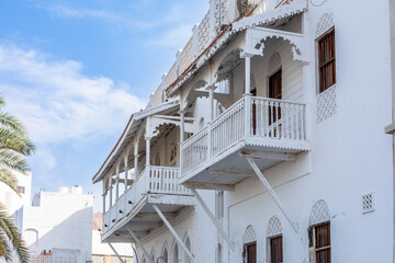 Traditional arab white buildings with decorated wooden windows and balconies, Mutrah, Muscat,...