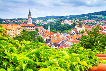 Obraz premium Summer cityscape - top view of the Old Town of Cesky Krumlov and the Vltava river flowing through it, Czech Republic