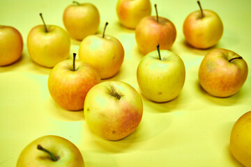 Modern minimalist still life with yellow apples on yellow background