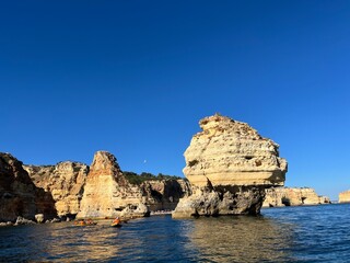Oddly shaped jagged rock formations and cliffs at Lagoa Beach, Faro District, Southern Portugal.