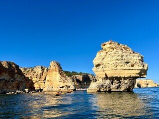 Oddly shaped jagged rock formations and cliffs at Lagoa Beach, Faro District, Southern Portugal.