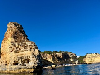 Oddly shaped jagged rock formations and cliffs at Lagoa Beach, Faro District, Southern Portugal.