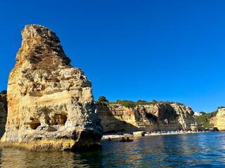 Oddly shaped jagged rock formations and cliffs at Lagoa Beach, Faro District, Southern Portugal.