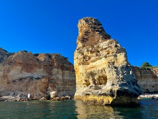 Oddly shaped jagged rock formations and cliffs at Lagoa Beach, Faro District, Southern Portugal.