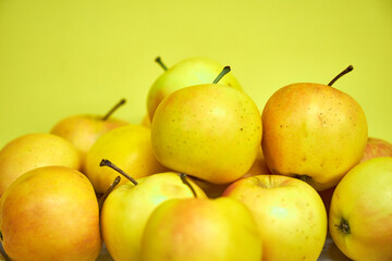 Modern minimalist still life with yellow apples on yellow background