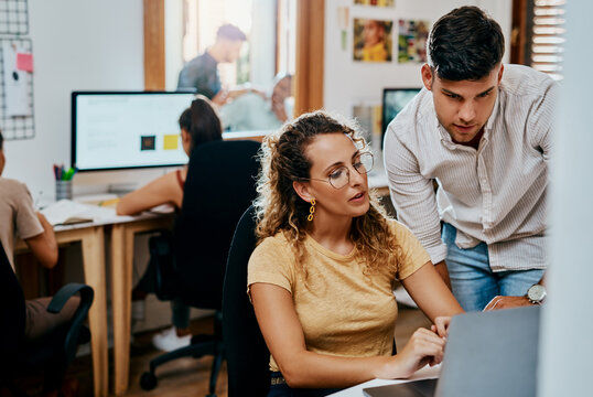 Business, employees and laptop in office for research results on creative ideas as magazine editor. Coworking, people and serious on website for teamwork, collaboration and strategy for project